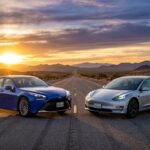 A sleek hydrogen fuel cell car and an electric vehicle side by side on an open road at sunset, representing the future of clean transportation